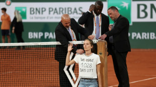 French Open semi-final halted as protester ties herself to net