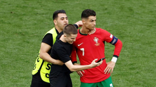 Portugal coach bemoans risk to player safety as pitch invaders chase Ronaldo selfies