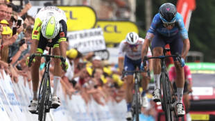 Cobble king Clarke wins Tour de France stage five with bike throw