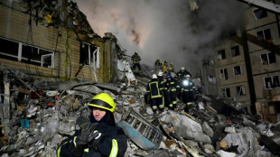 Anxious vigil outside destroyed Dnipro tower block