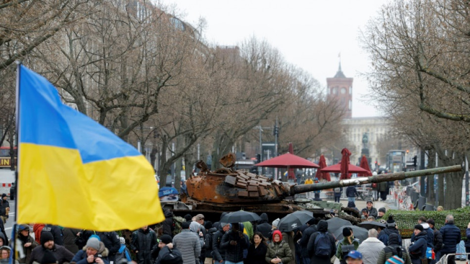 Tank wreck, protests mark Ukraine war anniversary in Europe