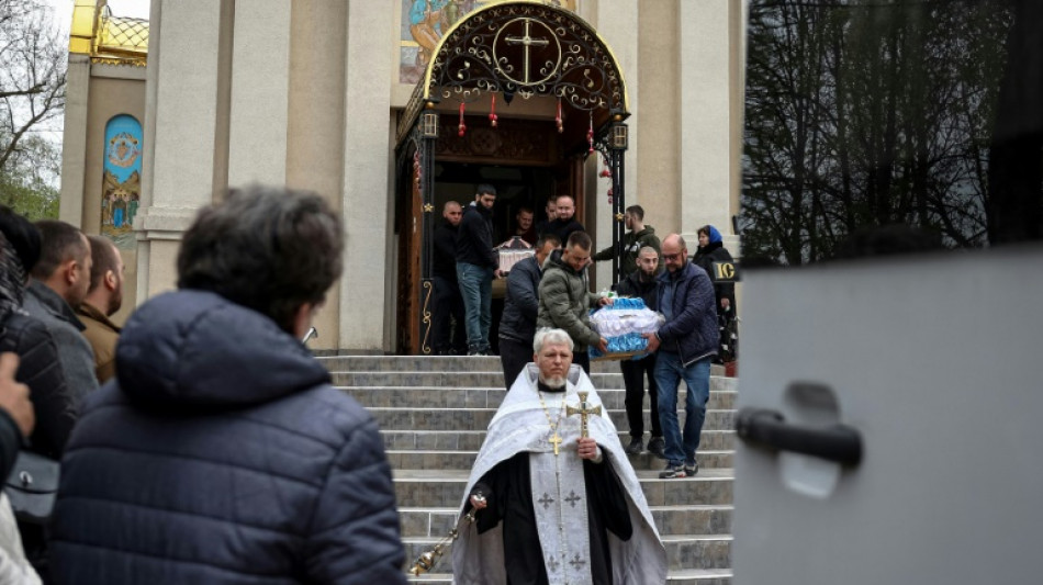 'Unbridled grief': Ukrainian woman buries toddler son, husband after strike