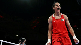 Algeria boxer in Olympics gender row into semis, wins at least bronze