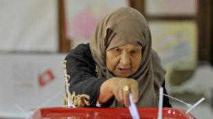 Tunisians vote for neutered parliament in poll shunned by opposition