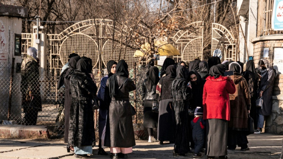 Armed guards stop Afghan women entering universities after Taliban ban