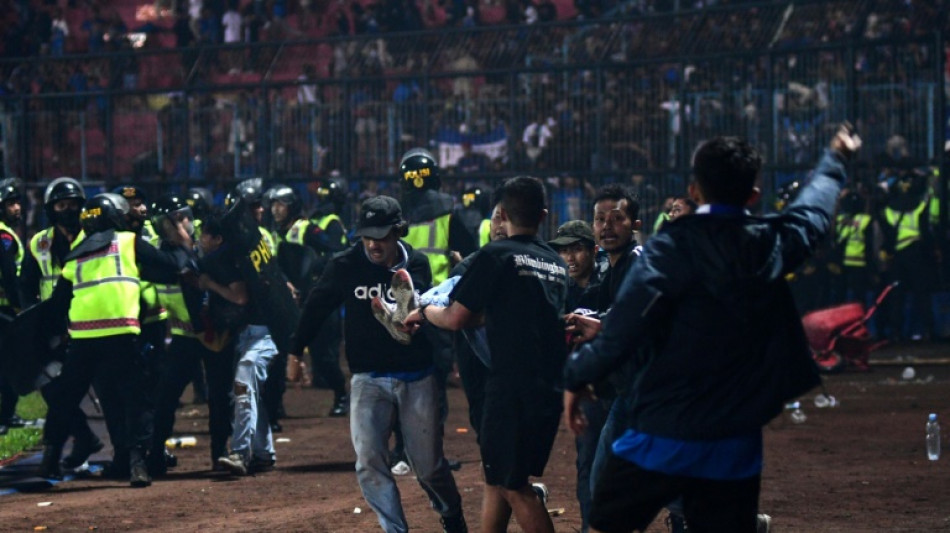 'Fans died in players' arms,' says coach at Indonesia football tragedy