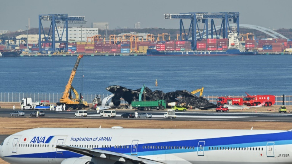 Plane wreckage being cleared from Tokyo airport after collision