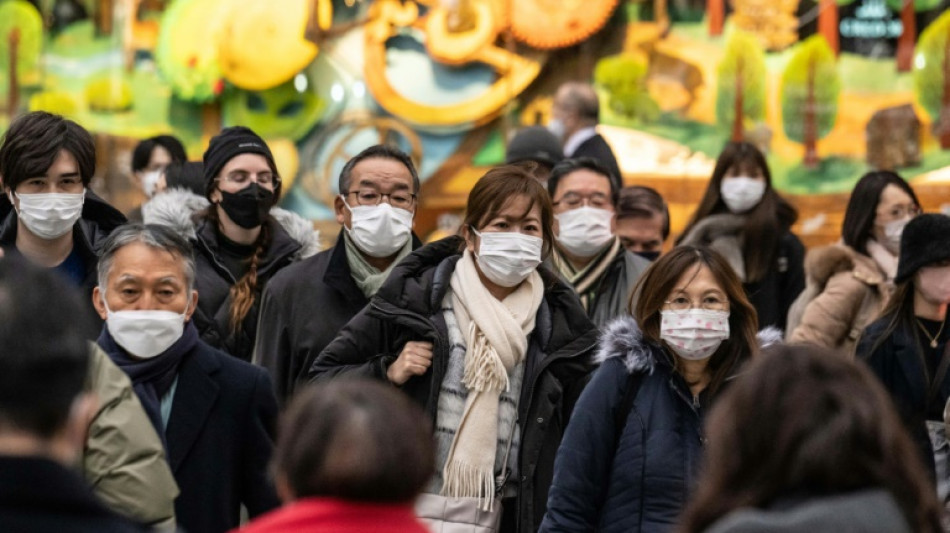 Japan to drop mask guidance, relax Covid strategy