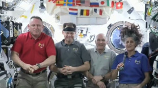 US astronauts upbeat seven months into eight-day mission