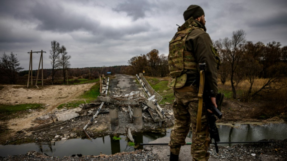 Ukrainian soldiers keep watch at recaptured border